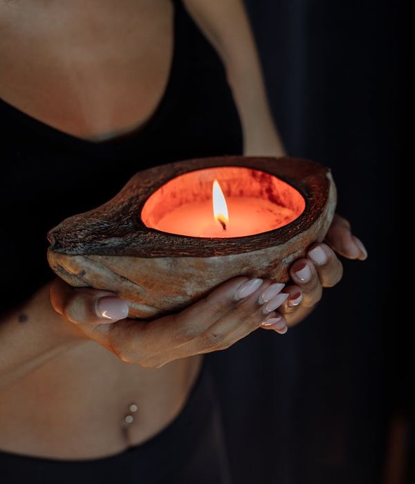 Woman in a calm yoga pose, bathed in warm, gentle light.